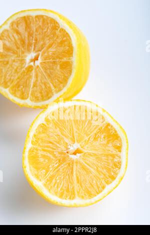 Lemon fruit cut in half, isolated on white background. Lemon cut in half isolated on white background. Stock Photo