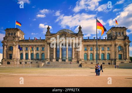 Berlin, Germany - April 30, 2014: The Reichstag building in Berlin. Flags of the Federal Republic of Germany are waving in front of the national germa Stock Photo