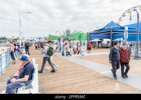 People enjoying a warm autumn day on Santa Monica Pier Stock Photo