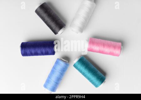 Composition with different thread spools on light background Stock Photo