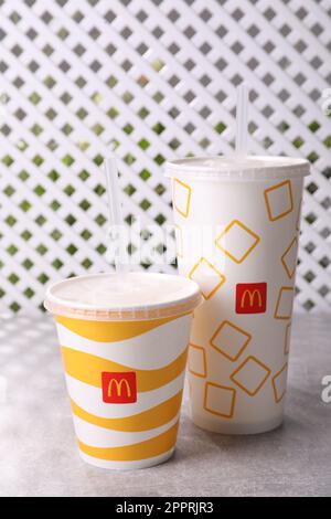 MYKOLAIV, UKRAINE - AUGUST 12, 2021: Cold McDonald's drinks on grey table Stock Photo