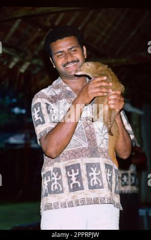 Man with Indian Brown Mongoose, Viti Levu, Fiji Stock Photo