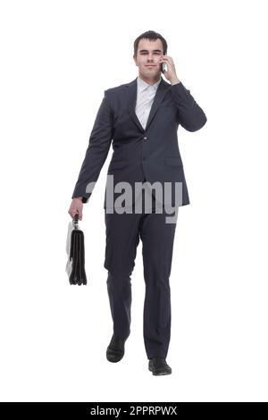 handsome young business man talking on a mobile phone and holding a suitcase on white background Stock Photo