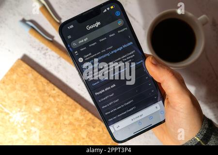 Gdansk, Poland - March 2023 Female hand holding cellphone Chat GPT app icon on screen of mobile phone iPhone Apple. Website of US American artificial intelligence company OpenAI LLC. Webpage prototype AI chatbot. Modern technologies  Stock Photo