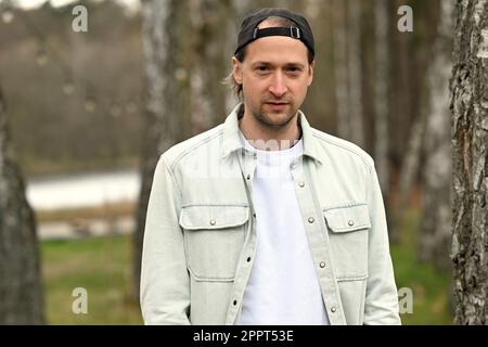 Rheinsberg, Germany. 19th Apr, 2023. Simon Triebel, guitarist from the band Juli, has his picture taken during a photo session at Landhaus Siebenwasser. The album new album of the band Juli, called 'The summer is over', will be released on 28.04.2023. Credit: Michael Bahlo/dpa/Alamy Live News Stock Photo