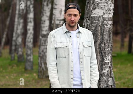 Rheinsberg, Germany. 19th Apr, 2023. Simon Triebel, guitarist from the band Juli, has his picture taken during a photo session at Landhaus Siebenwasser. The album new album of the band Juli, called 'The summer is over', will be released on 28.04.2023. Credit: Michael Bahlo/dpa/Alamy Live News Stock Photo