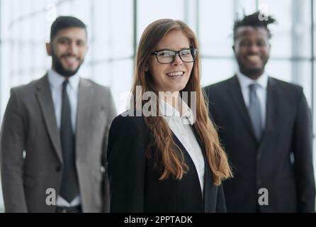 Serious manager posing in front of his two employees Stock Photo