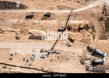 hydraulic drilling rig at construction site. heavy construction equipment for foundations construction work. aerial top view. Stock Photo