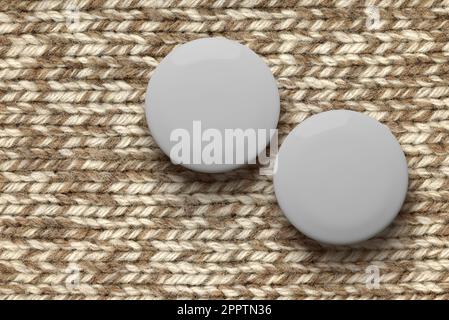 White round badge pin on brown knitted fabric, mock-up template. 3d rendering illustration. Stock Photo