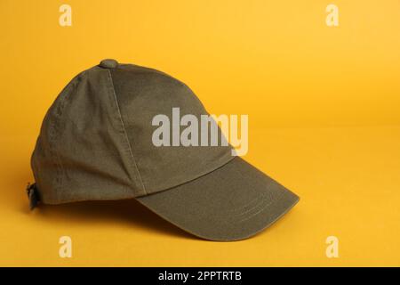 Baseball cap on yellow background, space for text Stock Photo
