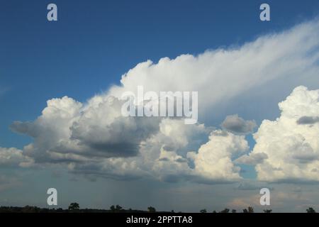 White fluffy clouds in the blue sky Stock Photo