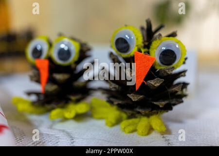 The birds are made of Christmas tree cones and felt. Children's creativity Stock Photo