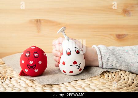 Close up view of girl child hand squeezing white homemade stress ball, made with flour and balloon. At home indoors. Stock Photo