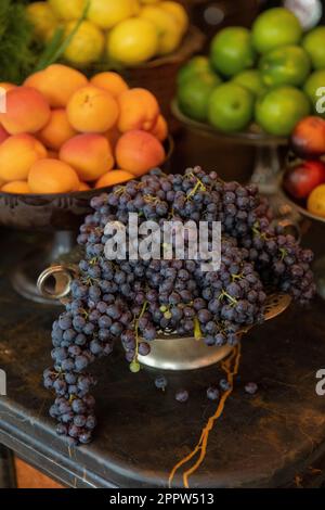 Still life fresh grapes, nectarines and citrus fruits in bowls Stock Photo