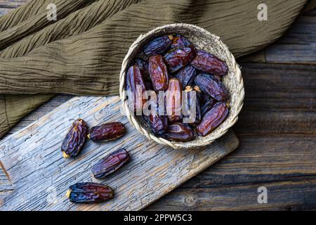 Dried date fruits, Ramadan Kareem, wooden background, top view. Stock Photo