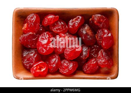 Dried cherries in clay bowl isolated on white flat lay view Stock Photo