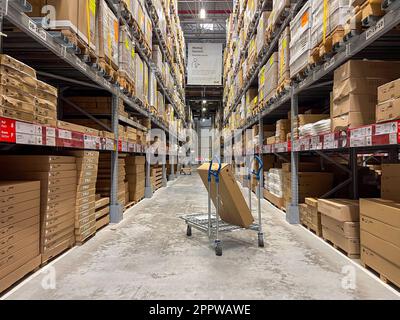Antalya, Turkey - April 1, 2023: A cart in warehouse aisle in an IKEA store Stock Photo