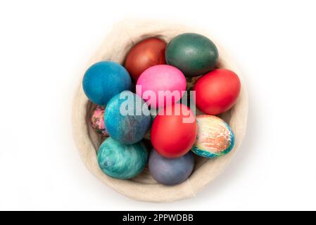 Multi colors Easter eggs in the woven basket isolated on white background with clipping path Stock Photo