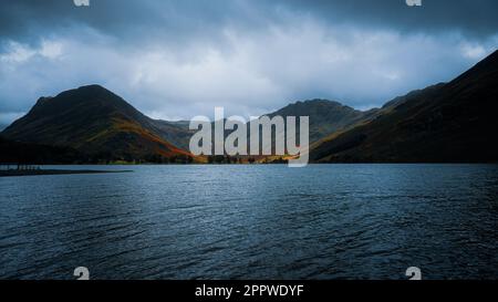 Views of the mountains overlooking a lake on a cloudy day in the Lake District Stock Photo