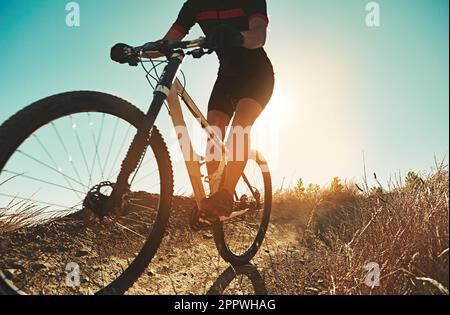 Mend your fuelish ways. an adventurous woman out cycling in the countryside. Stock Photo