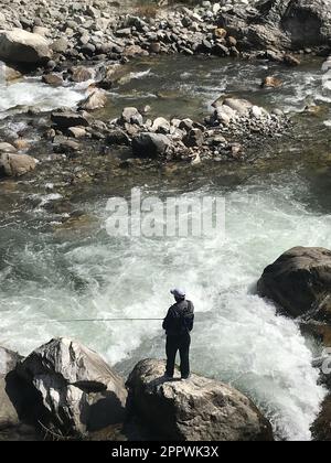 Overhead view of a man trout fishing in the Himalayas, Himachal Pradesh, India Stock Photo