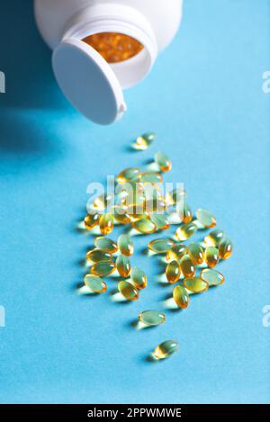 Oil filled capsules (softgel) of food supplements: fish oil, omega 3, omega 6, omega 9, vitamin A, vitamin D3, vitamin E, evening primrose oil, borage Stock Photo