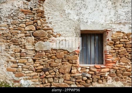Ancient stone rough facade with window Stock Photo