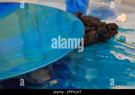The process of creating a home-made trendy abstract modern pattern painted  with acrylic resin. Woman artist in home studio. Epoxy resin Stock Photo -  Alamy
