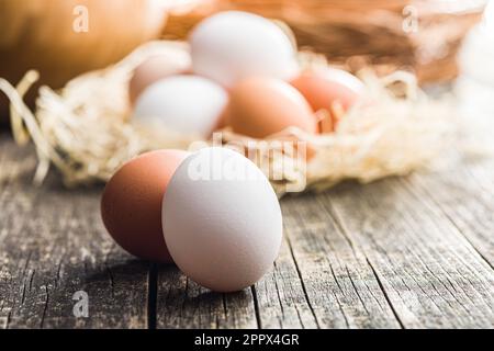 Whole chicken eggs on the wooden table. Stock Photo