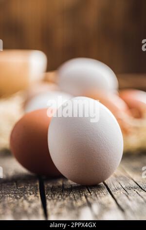 Whole chicken eggs on the wooden table. Stock Photo