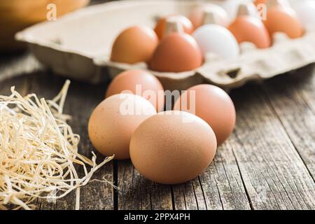 Whole chicken eggs on the wooden table. Stock Photo