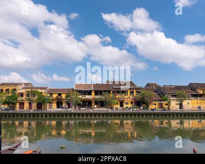 Old, traditional buildings along the river in Hoi An, Quang Nam province, Vietnam. The old city of Hoi An is a World Heritage Site, and famous for its Stock Photo