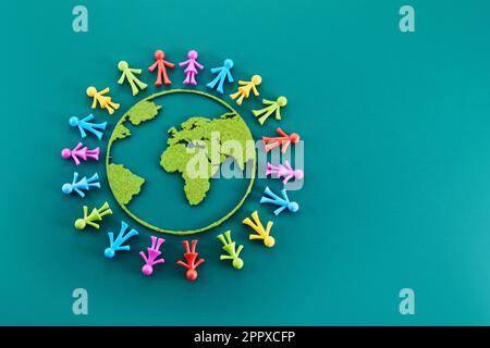 People from all around world standing on globe, Stock Photo