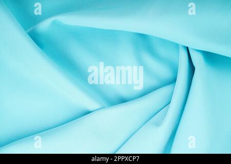 Twisted turquoise satin texture as background. Stock Photo