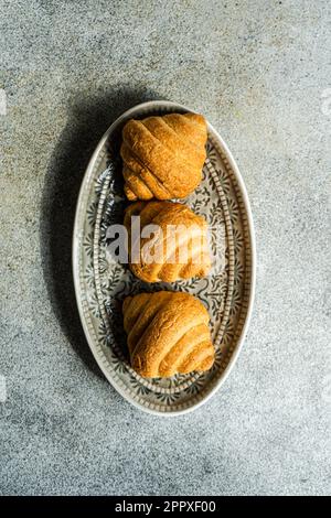 Top view of fresh baked croissants on the concrete background Stock Photo