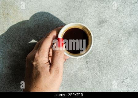 Top view of a Anonymous woman holding a cup of coffee Stock Photo