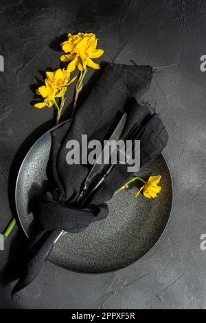 Top view of minimalistic table setting with tableware and cutlery on concrete background Stock Photo