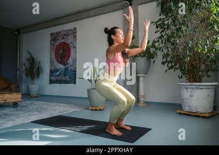 Fit Woman in Sportswear Practicing Yoga Gate Pose at Home. Stock Image -  Image of floor, daylight: 216846159