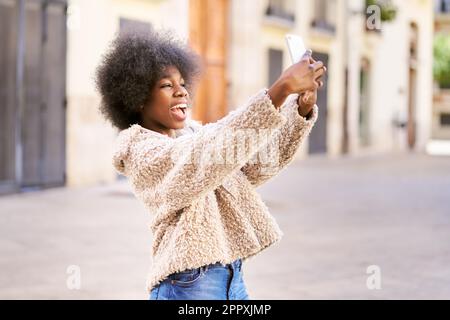 Free Photo  Sideways portrait of happy smiling female with curly bushy  hairstyle dressed casually thinks about something pleasant enjoys summer  rest in resort country happiness and positive emotions