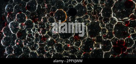 Many bubbles in dark oil Stock Photo