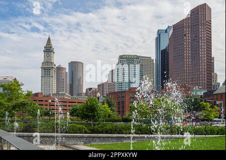 The skyline of the Boston Financial District with the historic Custom House Tower and modern office buildings seen from North End Parks Stock Photo