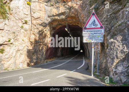 Tunnel with warning sign for cyclists, Tramuntana Mountains, Mallorca, Balearic Islands, Spain. Stock Photo