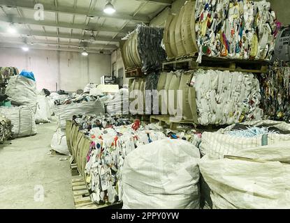 Moscow, Russia, November 2022: A huge storage for the collection of recyclables. Materials for processing are bound in huge bales. Stock Photo
