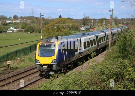 Northern Trains Civity class 195 dmu 195133 on West Coast Main Line near Scorton in Lancashire, 25th April 2023 with train to Manchester Airport. Stock Photo