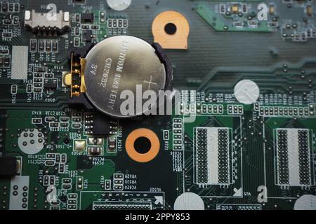 3 Volt lithium battery on the motherboard to feed the configuration memory and real time clock of the device. Battery-backed electronic cards. Focused Stock Photo