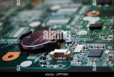 3 Volt lithium battery on the motherboard to feed the configuration memory and real time clock of the device. Battery-backed electronic cards. Focused Stock Photo