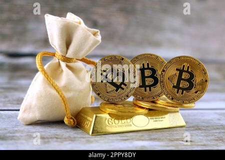 Physical version of Bitcoin, new virtual money. Conceptual image for investors in cryptocurrency and gold. Stock Photo