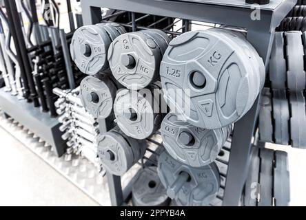 Samara, Russia - April 20, 2023: Sport a heavy barbell and more fitness equipment sold in the shop. Department of sporting goods. Sale of equipment fo Stock Photo