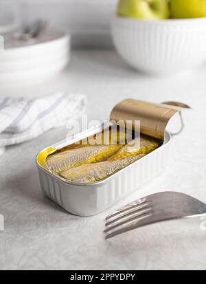 Canned sardines on kitchen table Stock Photo