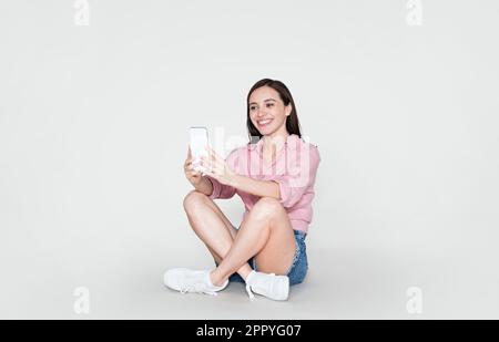 Happy summer lady enoying chat with her boyfriend, using smartphone Stock Photo